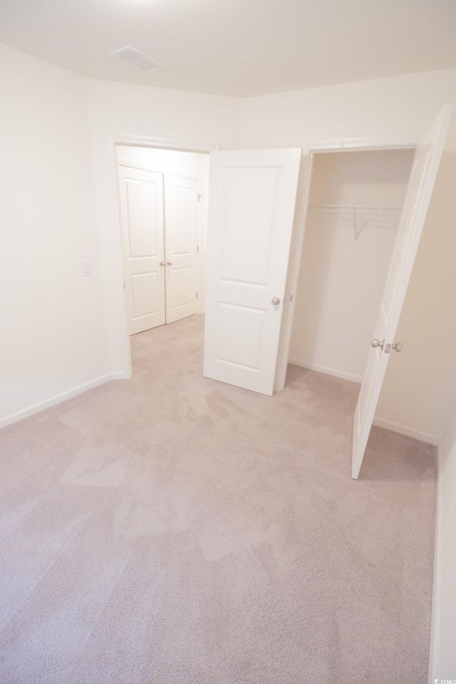 Unfurnished bedroom featuring light carpet, a closet, and baseboards | Image 16