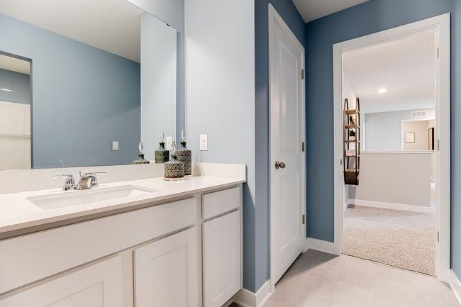 Those bedrooms each have easy access to this deep and spacious bathroom! Photo of model home, color & options may vary. | Image 24