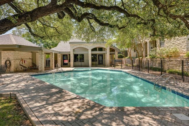 View of swimming pool featuring a pool with connected hot tub and a patio area | Image 30