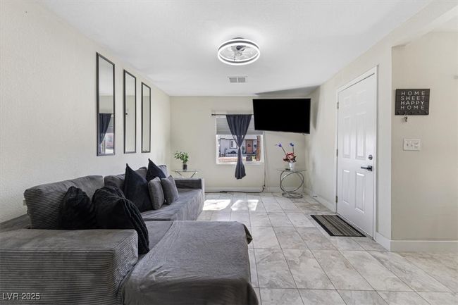 Living area with baseboards, visible vents, and marble finish floor | Image 7