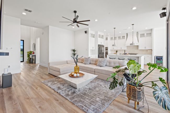 Living room with a ceiling fan, light wood-type flooring, recessed lighting, and wine cooler | Image 12