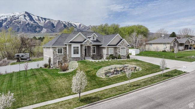 Craftsman house with concrete driveway, fence, stone siding, and a front yard | Image 13