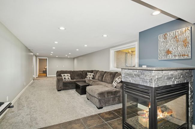 Lower level family room with fireplace. | Image 41