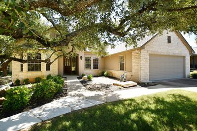 Native oaks drape their branches across the front yard allowing sunlight to dapple the front yard. | Image 2