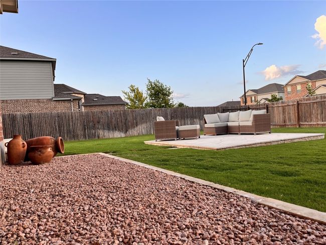 Fenced backyard featuring a patio area, outdoor lounge area, and a residential view | Image 40