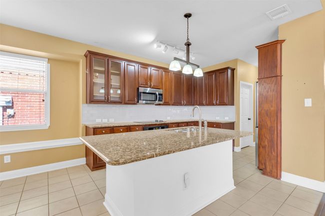 Kitchen featuring stainless steel microwave. | Image 6