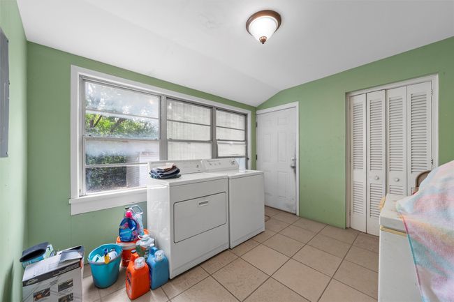 Washroom featuring washing machine and dryer and light tile patterned floors | Image 13