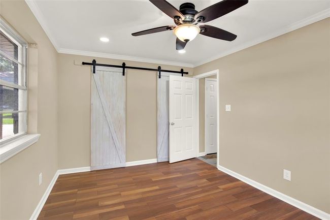 View of walk through closet space with barn doors | Image 15