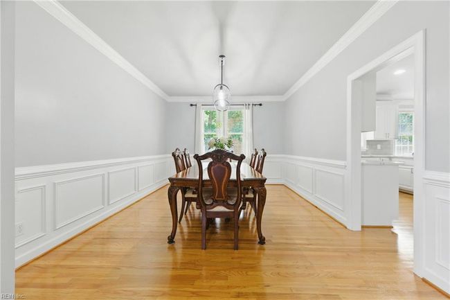 The Formal Dining Room is located at the rear-left of the home and features classic wainscoting... | Image 12