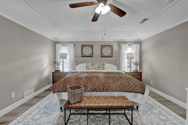Bedroom featuring light wood-style flooring, vaulted ceiling, and visible vents | Image 26