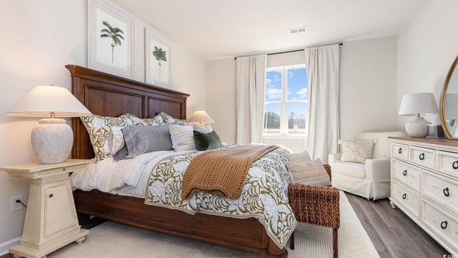 Bedroom featuring visible vents and wood finished floors | Image 12