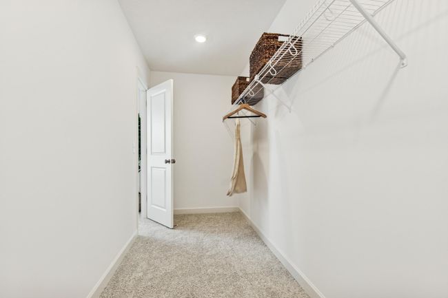 (Photo of model home, features will vary) A large walk-in closet with mesh-wire shelving provides abundant room to store wardrobes, shoes, accessories and much more | Image 12