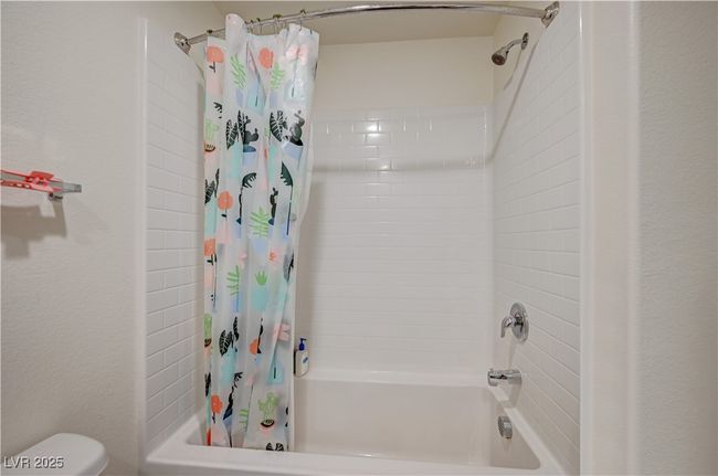 Full bathroom featuring shower / tub combo with curtain and toilet | Image 24