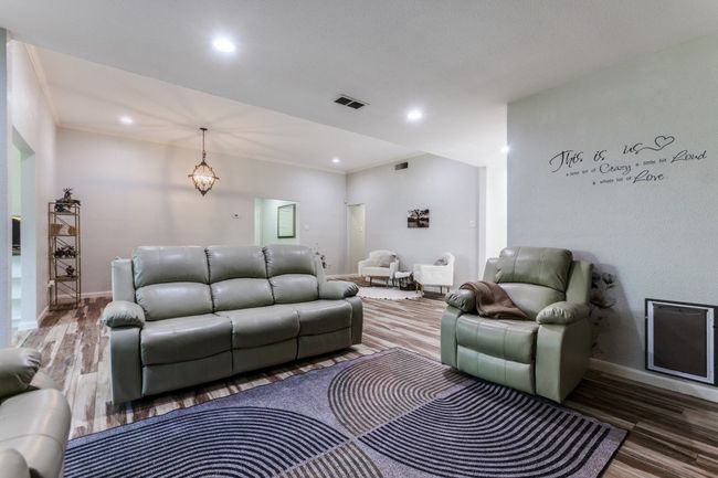Living area with wood finished floors and recessed lighting | Image 4