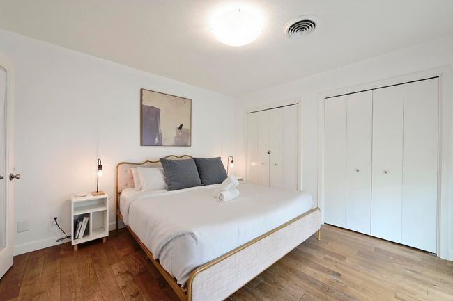This spacious bedroom off the entryway overlooks the front yard and comes with two sets of closets. | Image 31