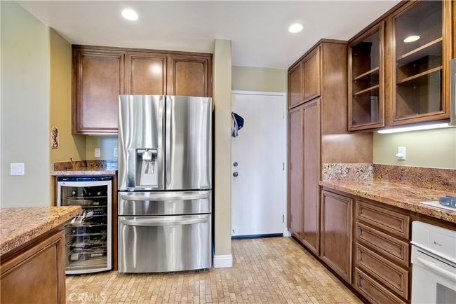 large pantry to right of photo, white door leads out to the spacious garage | Image 11