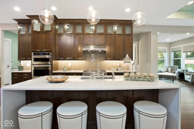 The expansive kitchen island doubles as a spacious eating area-perfect for quick meals or hosting guests. | Image 7