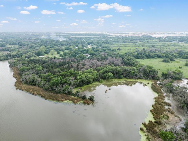 Aerial view featuring a wooded view and a water view | Image 6