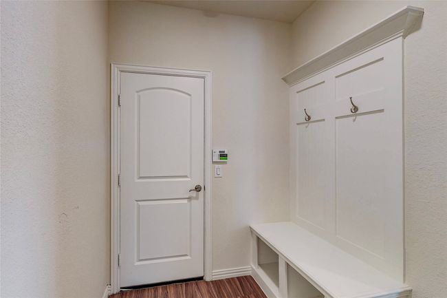 Mudroom featuring dark wood-style flooring and baseboards | Image 25