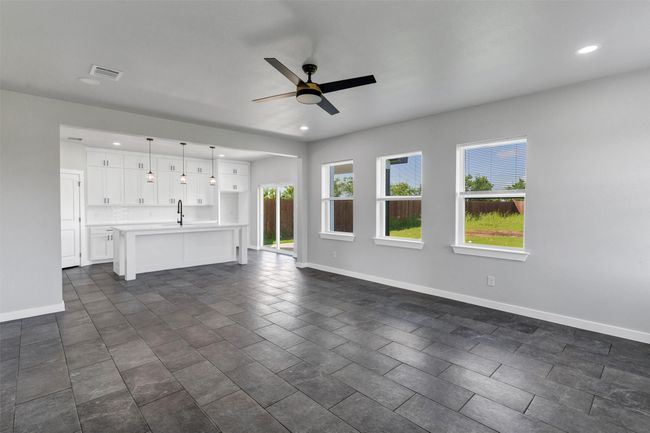 Unfurnished living room featuring a sink, plenty of natural light, baseboards, and recessed lighting | Image 12