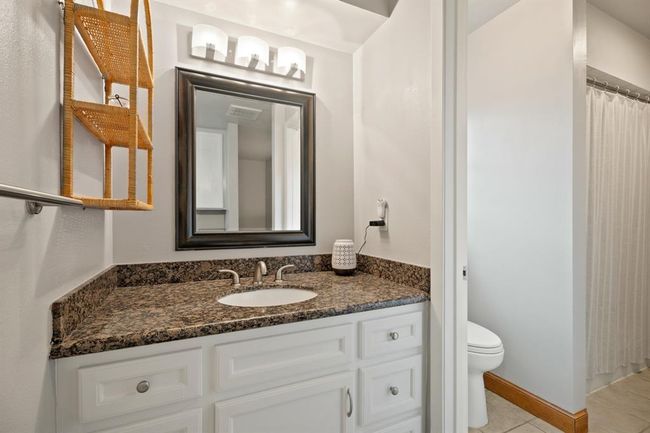Opposite end of the secondary bathroom - complete with granite countertops. | Image 27