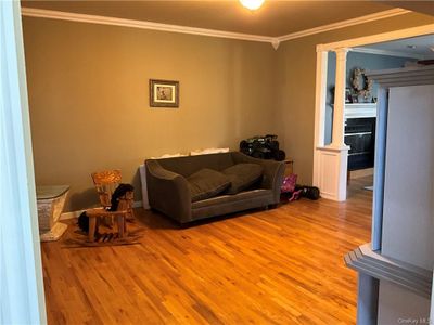 Living room featuring light hardwood / wood-style flooring and ornamental molding | Image 3