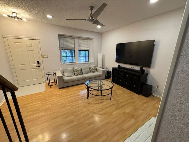 Living room featuring ceiling fan, light wood-style floors, recessed lighting, and a textured ceiling | Image 5