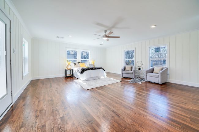 Bedroom with ornamental molding, dark hardwood / wood-style floors, and ceiling fan | Image 19