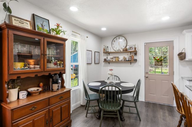 Dining space featuring dark wood finished floors, plenty of natural light, and recessed lighting | Image 12