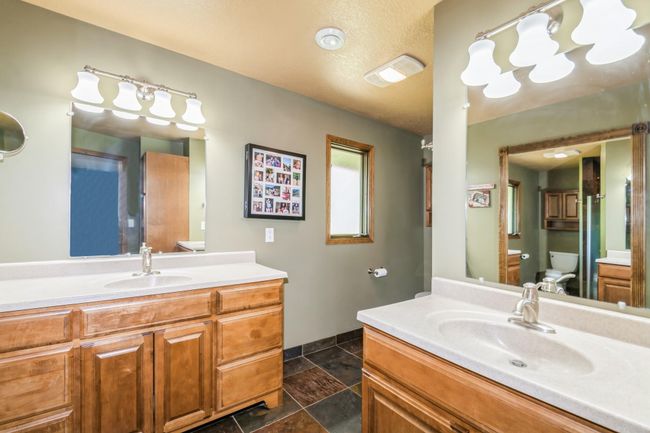Private primary bathroom has dual sinks, 3/4 shower and tiled flooring! | Image 32