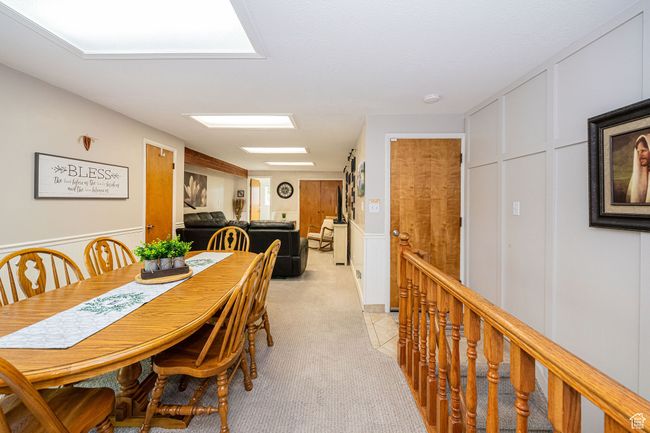 Dining area with a decorative wall, light carpet, and a wainscoted wall | Image 21