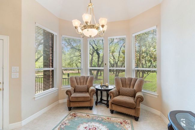 Dining area featuring a chandelier, light tile patterned floors, and baseboards | Image 18