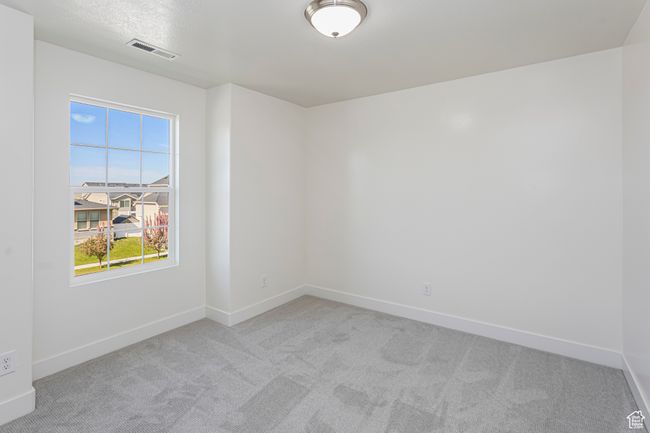 Carpeted spare room featuring baseboards and visible vents | Image 21