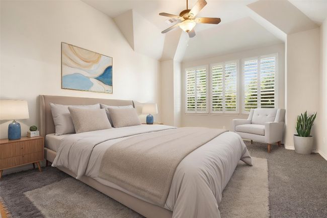 The private primary suite is thoughtfully positioned in a mother-in-law layout, offering added privacy and comfort. Featuring elegant plantation shutters and a spacious design, this serene retreat is perfect for unwinding at the end of the day. *Virtually Staged* | Image 4