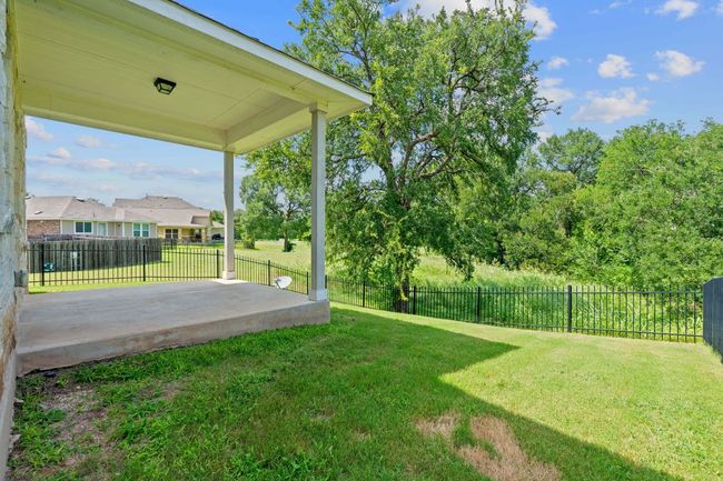 Fenced backyard with a patio | Image 34