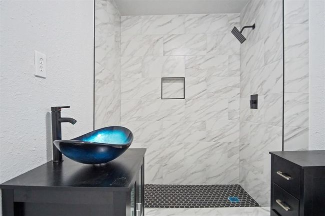 Bathroom featuring vanity and a tile shower | Image 5