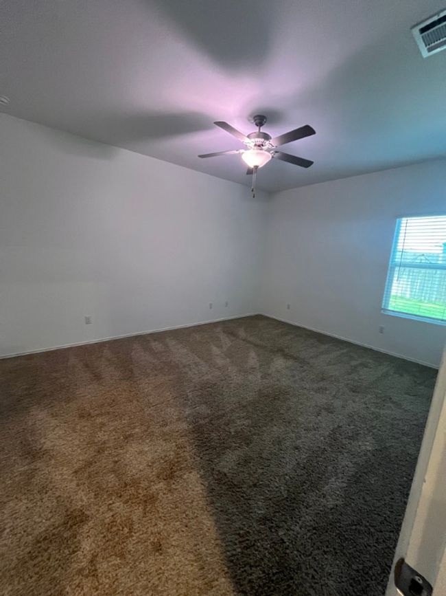 Unfurnished main room with carpet floors and ceiling fan | Image 13