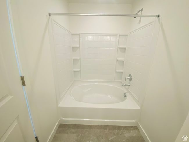 Bathroom with baseboards and shower / bathtub combination | Image 15