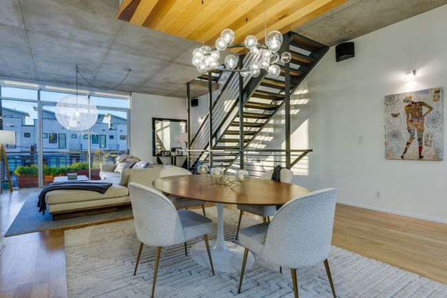 Dining space with hardwood / wood-style flooring, a wall of windows, and a chandelier | Image 11