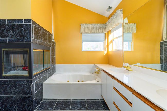 Primary Bathroom with a jacuzzi tub, lofted ceiling. | Image 27