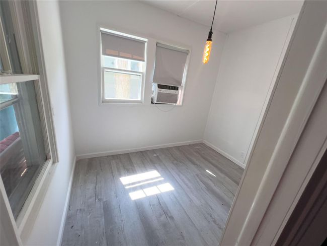 Unfurnished room with cooling unit and light hardwood / wood-style flooring | Image 6