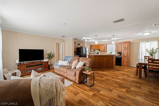 Living room with crown molding and hardwood / wood-style flooring | Image 6