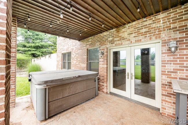 View of patio / terrace featuring french doors and a hot tub | Image 45