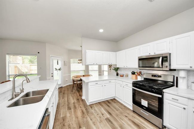 Another angle of the beautiful kitchen — offering ample space, sleek finishes, and an abundance of natural light. | Image 18