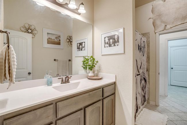 Full bath with vanity, tile patterned floors, and a shower with curtain | Image 27