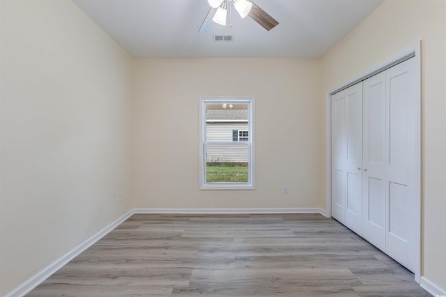 Unfurnished bedroom featuring light wood-type flooring, a closet, and baseboards | Image 13