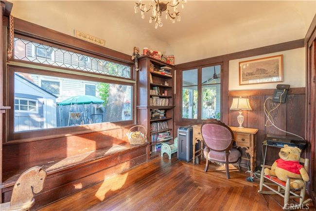 Gather in this light-filled dining space framed by vintage windows and original cabinetry. | Image 7