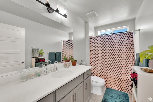 Bathroom with vanity and curtained shower | Image 23