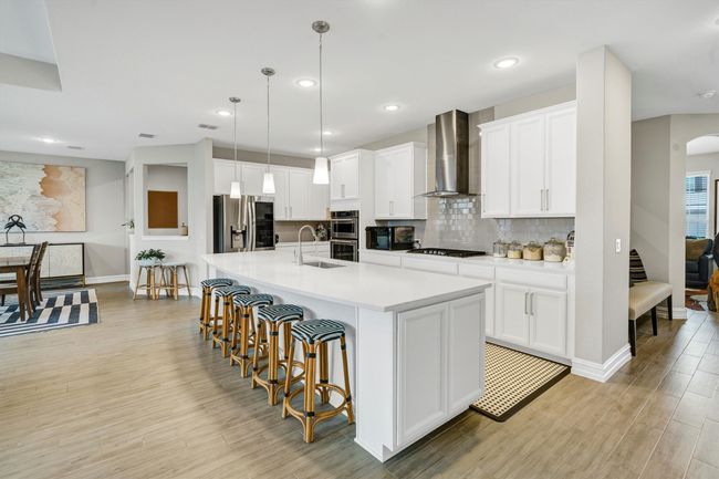 Gorgeous kitchen features stainless steel appliances, Quartz countertops and an oversized island. | Image 11