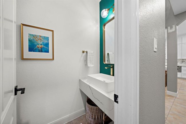 The guest bathroom on the first floor presents a fun and elegant look and feel. | Image 33